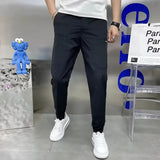 Men's slim fit black cargo pants featuring a tapered style, shown with a person standing, emphasizing the pants' versatile and stylish design.