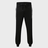 Men's slim fit black joggers designed for gym and casual wear, featuring zipper pockets, shown on a model.