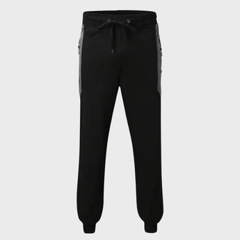 Men's slim fit black joggers designed for gym and casual wear, featuring zipper pockets, shown on a model.