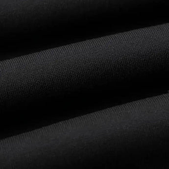 Men's slim fit black joggers with zipper pockets laid flat on a white background, showcasing the sleek design and functional pocket features suitable for gym and casual wear.
