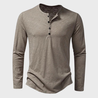 Men's slim fit black long sleeve Henley shirt made from a cotton blend material, featuring a button-up collar design.