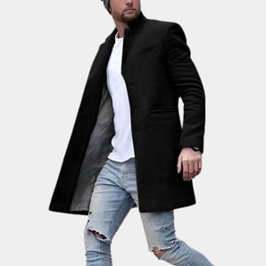 Men's slim fit black trench coat styled with a dress shirt, showcasing the shoulder and arm detailing, ideal for winter fashion.