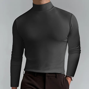 A man wearing a black slim fit turtleneck shirt with long sleeves, showcasing an elegant and sophisticated look.