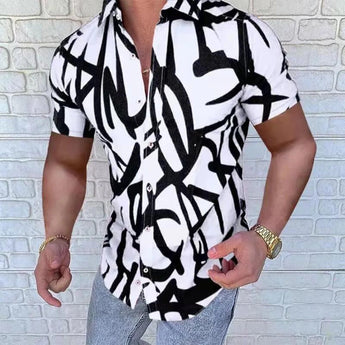 
A man wearing a slim fit black and white abstract graffiti shirt, featuring long sleeves and a button-up style. The shirt has a crisp white background with bold black graffiti patterns. The model is standing upright, showcasing the shirt's design and fit, suitable for casual or semi-formal occasions.