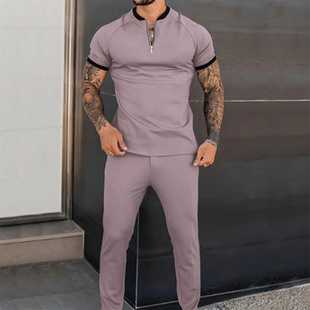 Men's grey slim fit zipper polo shirt in 3XL, showcasing a stylish design that highlights tattoos, with focus on the upper body and sleeves.