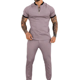 Men's slim fit black zipper polo shirt with a stylish collar and short sleeves, showcasing a tattoo-friendly design suitable for casual or sporty occasions.