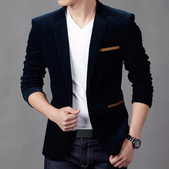 Men's slim fit brown corduroy blazer paired with a white dress shirt, showcasing a casual business fashion style. The outfit includes long sleeves and a collar, with a visible wristwatch completing the look.
