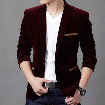 Men's slim fit brown corduroy blazer paired with a white dress shirt, showcasing a casual business fashion style. The blazer has a well-defined collar and sleeves, with a focus on tailoring around the waist. The outfit is completed with jeans and a watch, providing a modern, relaxed yet professional look.