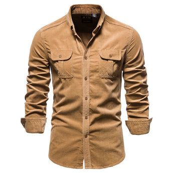 Men's slim fit dark blue denim shirt with long sleeves, featuring a classic collar and button closure, displayed in a casual setting.