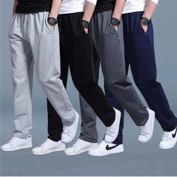 Men's slim-fit fleece joggers with cuffed ankles in a multipack, demonstrating the fit on a model's legs, waist, and knees, emphasizing the overall sleek and modern appearance of the trousers.