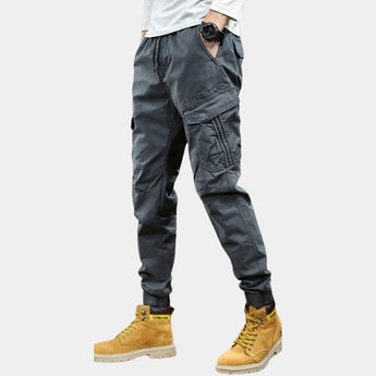 Men's slim fit multi-pocket cargo pants in green, featuring a military-inspired design with multiple pockets, shown in a dark gray variant, waist size 33.