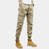 Men's slim fit green military-style cargo pants with multiple pockets, shown in khaki color, size 33, emphasizing the fit around the legs and knee area.