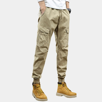 Men's slim fit green military-style cargo pants with multiple pockets, shown in khaki color, size 33, emphasizing the fit around the legs and knee area.