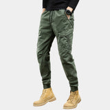 Men's slim fit light green military multi-pocket cargo pants, showcasing the waist, leg, and thigh areas, with visible pockets and stitching details.