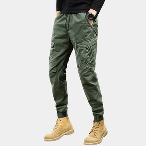 Men's slim fit light green military multi-pocket cargo pants, showcasing the waist, leg, and thigh areas, with visible pockets and stitching details.