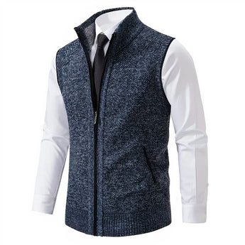 Men's slim fit herringbone tweed vest in brown wool blend, shown on mannequin, featuring button closure, v-neckline, and sleeveless design.