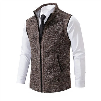 Men's slim fit herringbone tweed vest in brown wool blend, featuring a buttoned front and a tailored design, paired with a formal dress shirt.