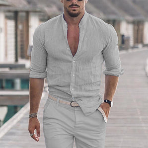 Man wearing a men's slim fit linen gray shirt in 3XL, showcasing a breathable summer fashion style, standing and accessorized with a watch and eyewear.