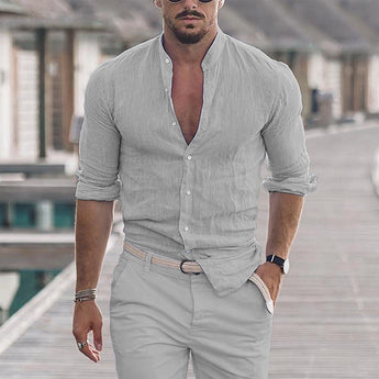 Man wearing a men's slim fit linen gray shirt in 3XL, showcasing a breathable summer fashion style, standing and accessorized with a watch and eyewear.