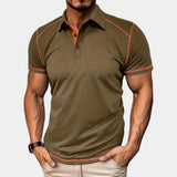 Men's slim-fit navy blue athletic polo shirt with contrast piping, featuring short sleeves and a comfortable fit, worn by a model.