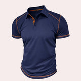 Men's slim-fit navy blue athletic polo shirt featuring contrast piping, short sleeves, and a collar suitable for sportswear.