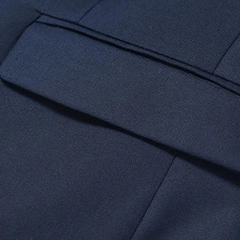 Men's slim fit navy blue blazer with formal design, featuring long sleeves and a sleek appearance suitable for evening and party wear.