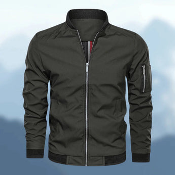 Men's lightweight bomber jacket in navy, with a slim fit design. Features a zipper pocket, ribbed collar, and cuffs.