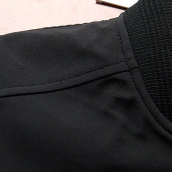 Men's slim fit navy bomber jacket featuring a zipper pocket, lightweight fabric, and long sleeves.