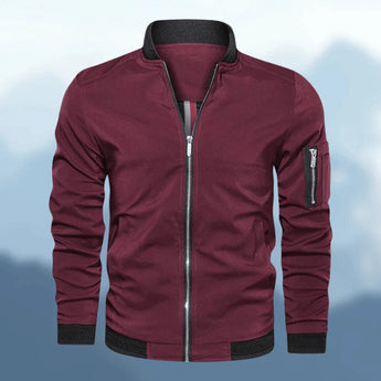 Men's slim fit navy bomber jacket featuring a zipper pocket, with a lightweight design and a classic collar and sleeves.