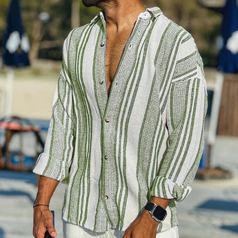 Men's casual lightweight beachwear featuring a green XL striped linen shirt, shown on a model with a stylish hairstyle and wearing eyewear, highlighting the shirt's dress shirt design with a collar and long sleeves.