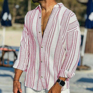 
A pink, men's striped linen shirt in XL size, designed as casual lightweight beachwear. The shirt features long sleeves and a fashionable pattern, ideal for relaxed outdoor settings.