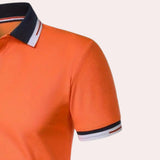 Men's orange polo shirt with a contrast collar, short sleeves, and breathable fabric, designed for comfort and style.