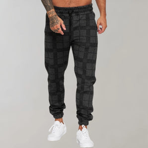 Men's stylish black checkered tartan joggers, size 3XL, featuring a plaid pattern with a comfortable fit around the legs and thighs.