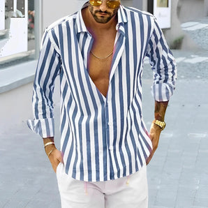 Man wearing a blue and white striped long sleeve shirt with a casual relaxed fit, featuring a 3XL size. The shirt is styled with a hat and eyewear, embodying a summer look.