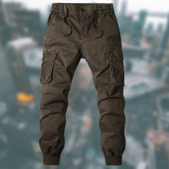 Men's tactical cargo pants in coffee color, featuring a durable and water-resistant fabric with multiple pockets, shown in 3XL size, showcasing the thigh and waist areas.
