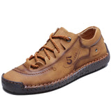 Men's tan leather sneakers featuring hand-stitched detailing, durable construction, and breathable materials, suitable for both athletic and casual wear.
