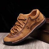 Men's tan leather sneakers featuring a hand-stitched design, suitable for outdoor activities, with a durable and breathable construction, shown in a stylish brown shade.