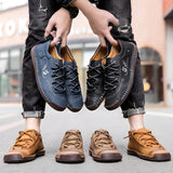 Men's tan leather sneakers with hand-stitched detailing, shown from a side angle on a white background.