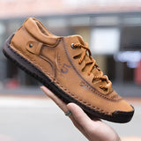 Men's tan leather sneakers with hand-stitched detailing, showcasing durability and breathability, ideal for walking and outdoor activities.