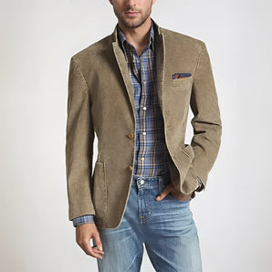 Men's tan suede blazer with elbow patches, styled as an autumn jacket in persimmon color, displayed in a 2XL size. The model pairs the blazer with jeans and a dress shirt, showcasing the sleeve detail.