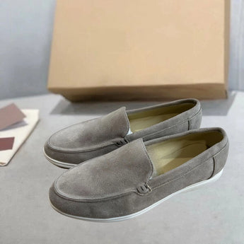 Men's tan suede loafers featuring comfortable slip-on design, contrast stitching, and leather construction, displayed in light gray size 47.