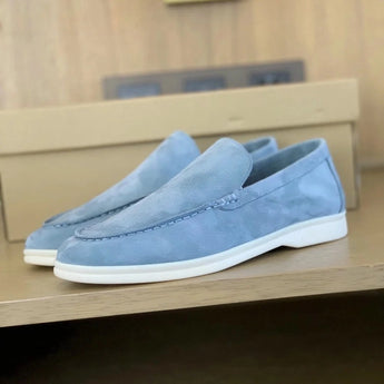 Men's tan suede loafers with contrast stitching, displayed on a light blue background, size 47, showcasing a slip-on design with a comfortable fit.