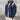 Men's tan teddy bear hoodie zip-up fleece jacket in faux fur, featuring long sleeves and a cozy collar. The model is wearing a marine blue variant in XL size, complementing the outerwear with a grey backdrop and beard, highlighting the garment's soft texture and stylish design.
