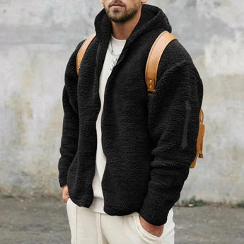 Men's tan teddy bear hoodie in faux fur fabric, featuring a zip-up front and fleece material. The hoodie includes a collar, sleeves, and waist that contribute to its cozy design. Displayed in a black color variant, size XL.