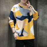 Men's oversized streetwear pullover sweatshirt in a trendy yellow camo pattern, featuring long sleeves and a relaxed fit.