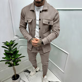 Men's two-tone blue lightweight tracksuit in deep cachi 3XL, featuring a stylish urban design. The image shows the tracksuit being worn by a standing model. A houseplant and flowerpot are visible in the background, adding a touch of greenery to the setting.