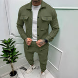 Men's two-tone blue tracksuit in military green, size 3XL, featuring a sleek design with long sleeves and a collar, modeled in an urban setting with plants in the background.