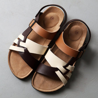 Men's brown two-tone leather sandals with adjustable strap and cork sole, size 47, displayed on a wooden surface.
