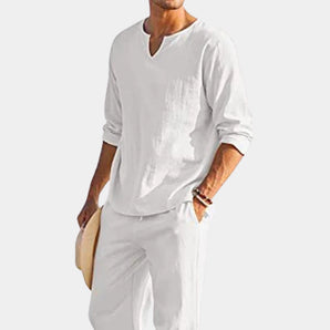 Men's white linen Henley shirt with long sleeves, designed in a relaxed fit suitable for beachwear. The shirt features a casual, comfortable style with a classic neckline.