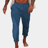 Men's blue linen pants in size 3XL, featuring a lightweight and breathable fabric with an elastic waist, shown on a model standing.
